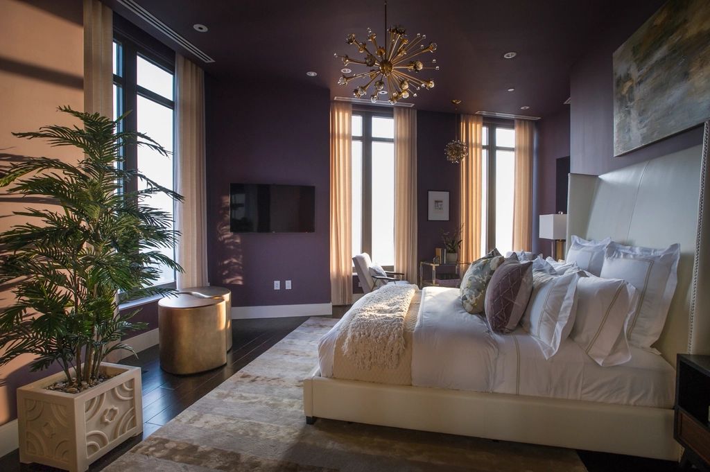 A guest room with a large bed and soft lighting