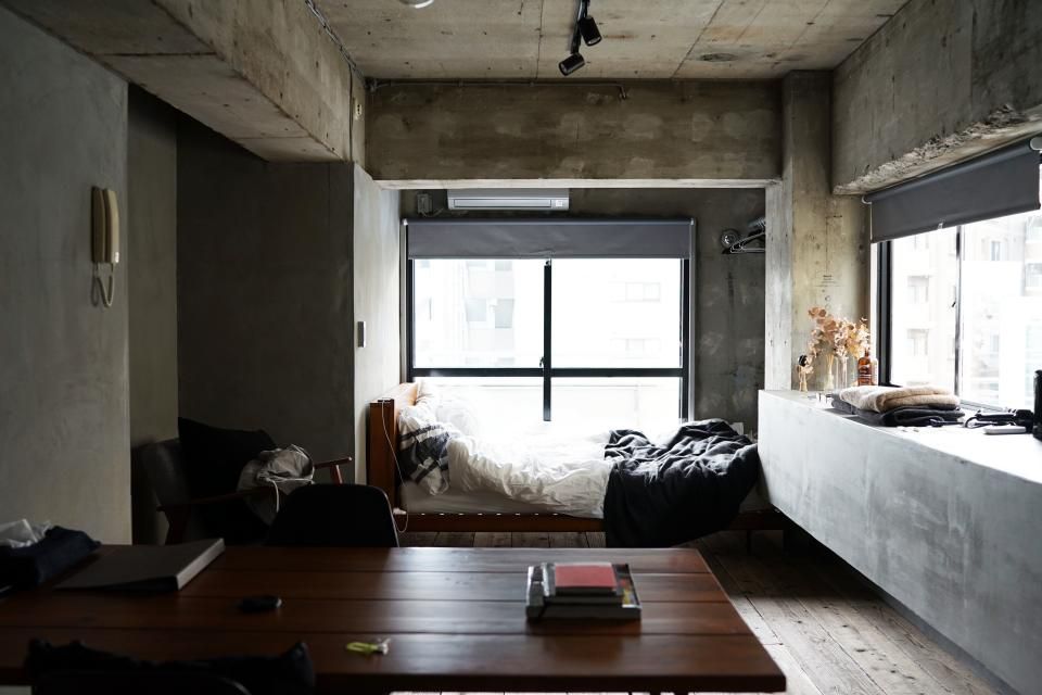 A guest room with two beds and a window